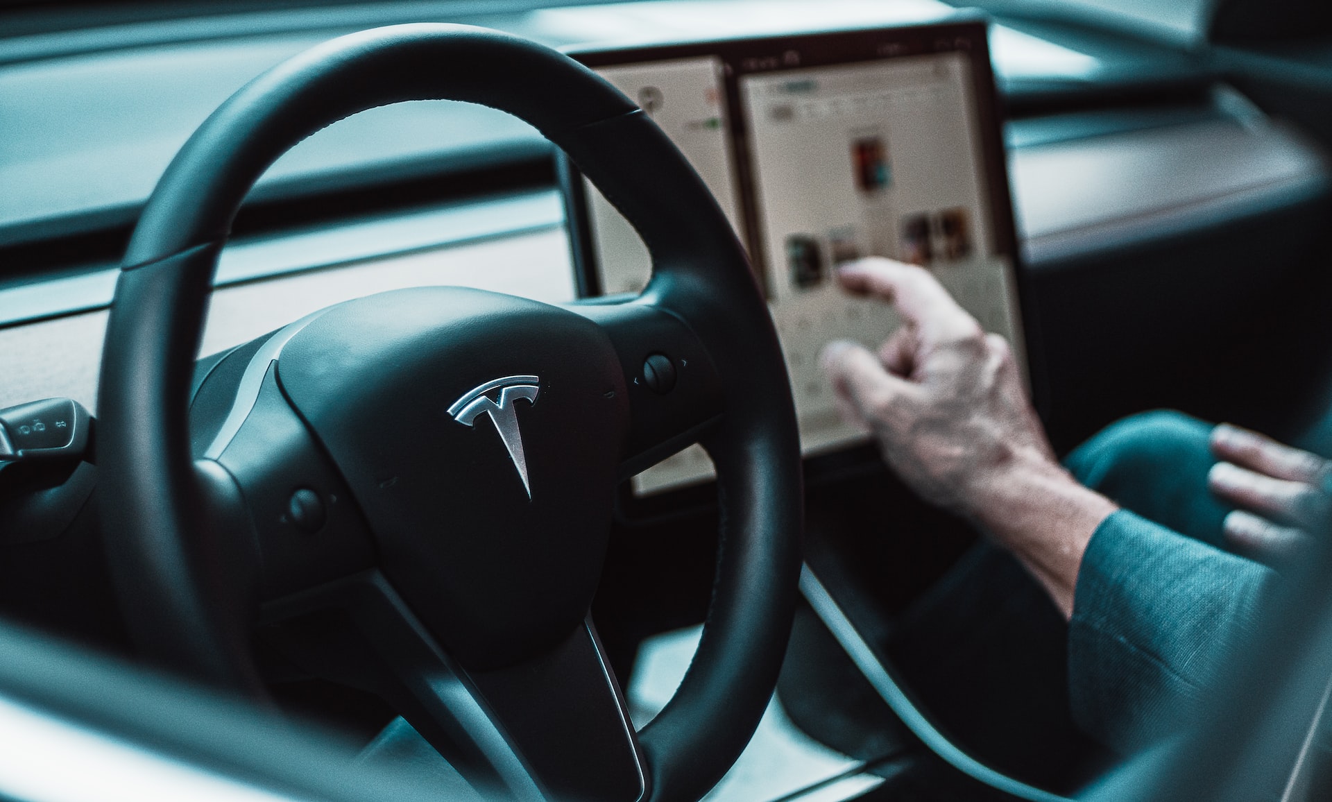 Image of a man driving a tesla as one of the top 8 reasons to renting a tesla in toronto canada